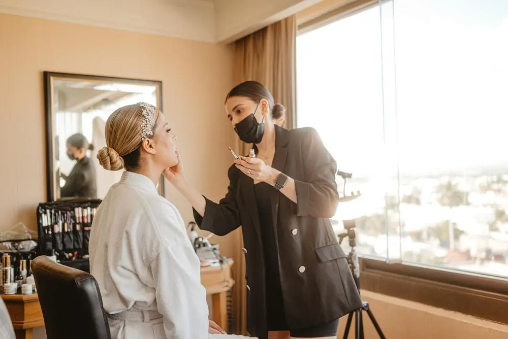 Makeup artist preparing a client
