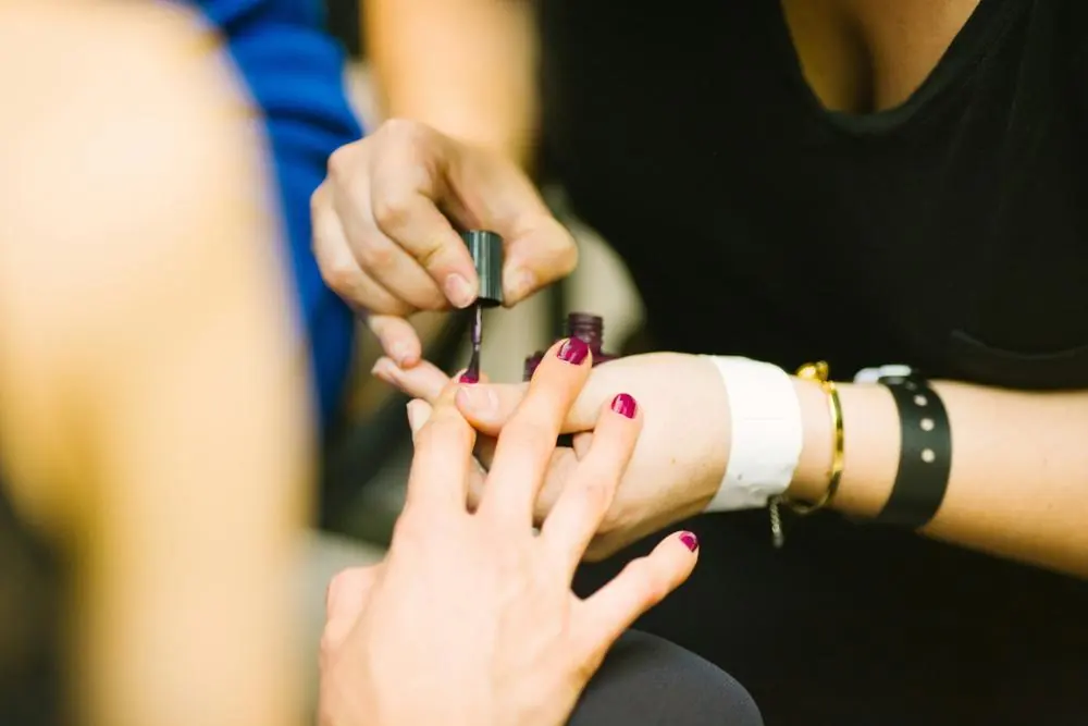 Nail technician painting nails